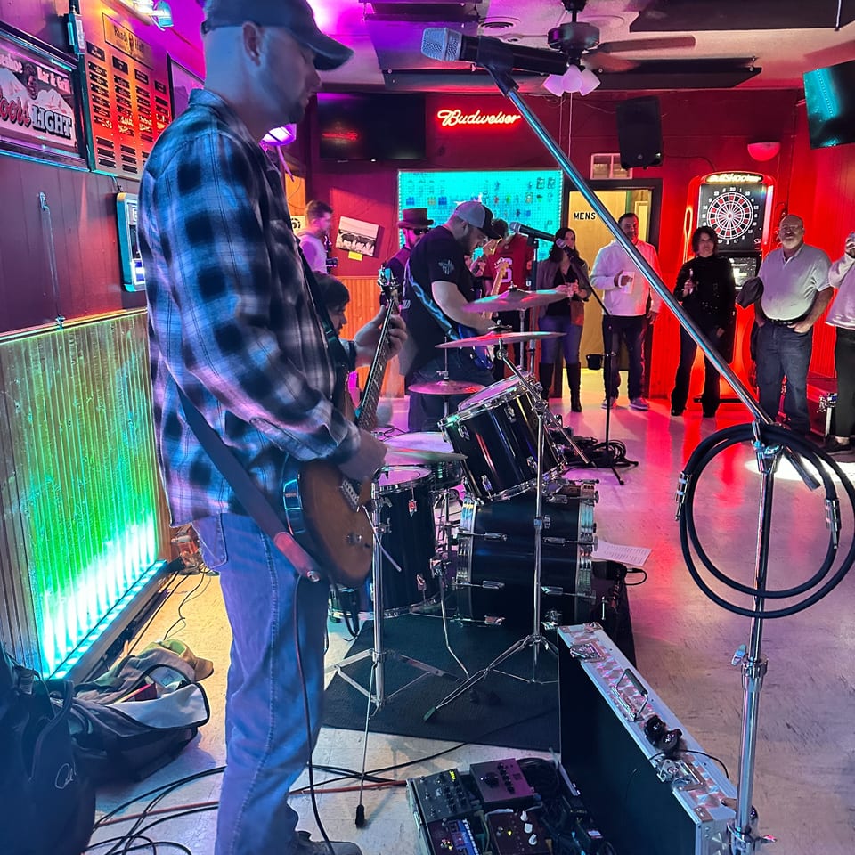 A band performs live music at The Horseshoe Bar & Grill, with patrons watching.